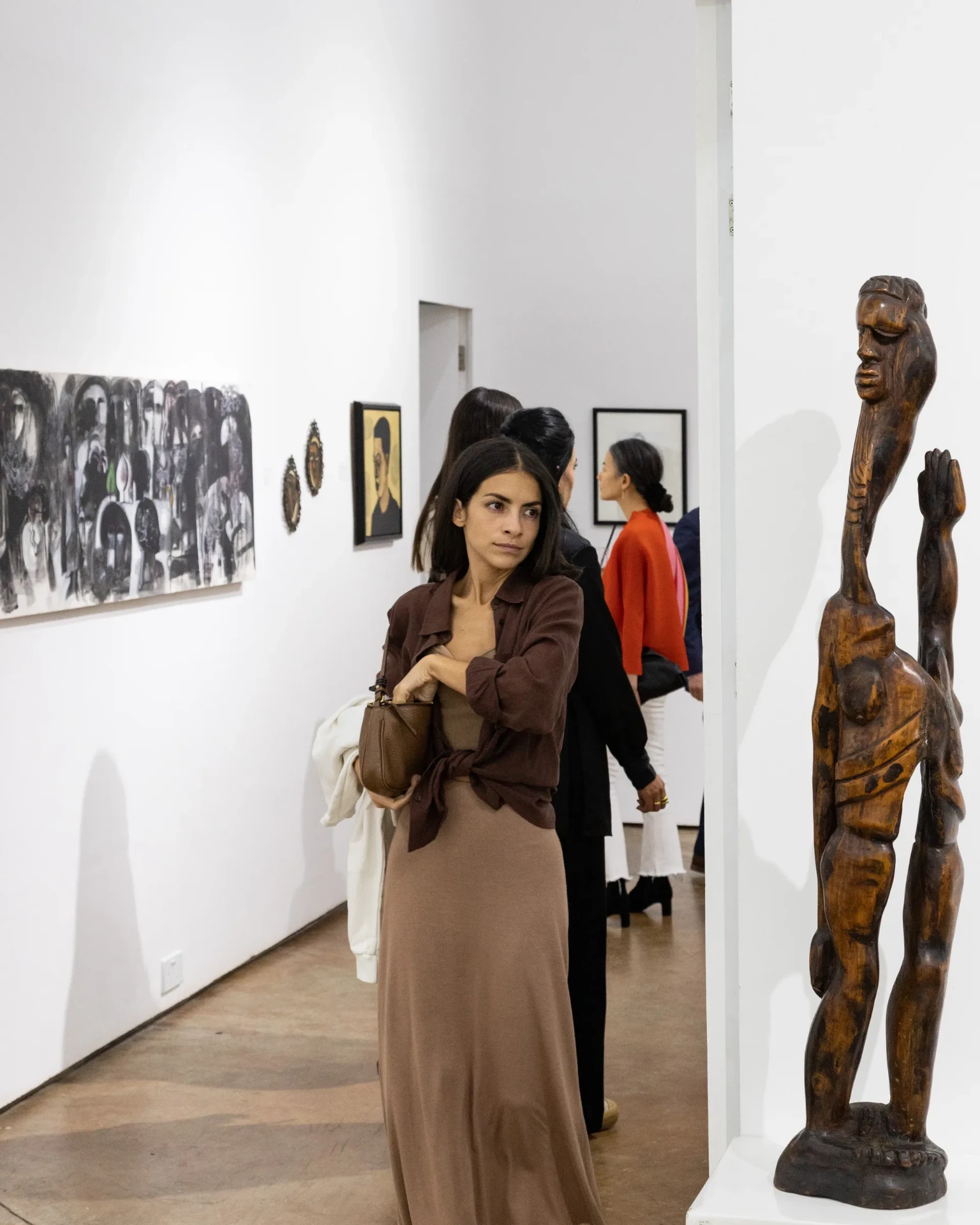 Guest in the gallery beside a carved sculpture